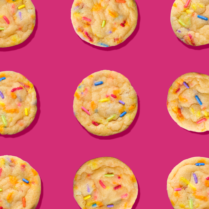 Several cookies with sprinkles on a pink background